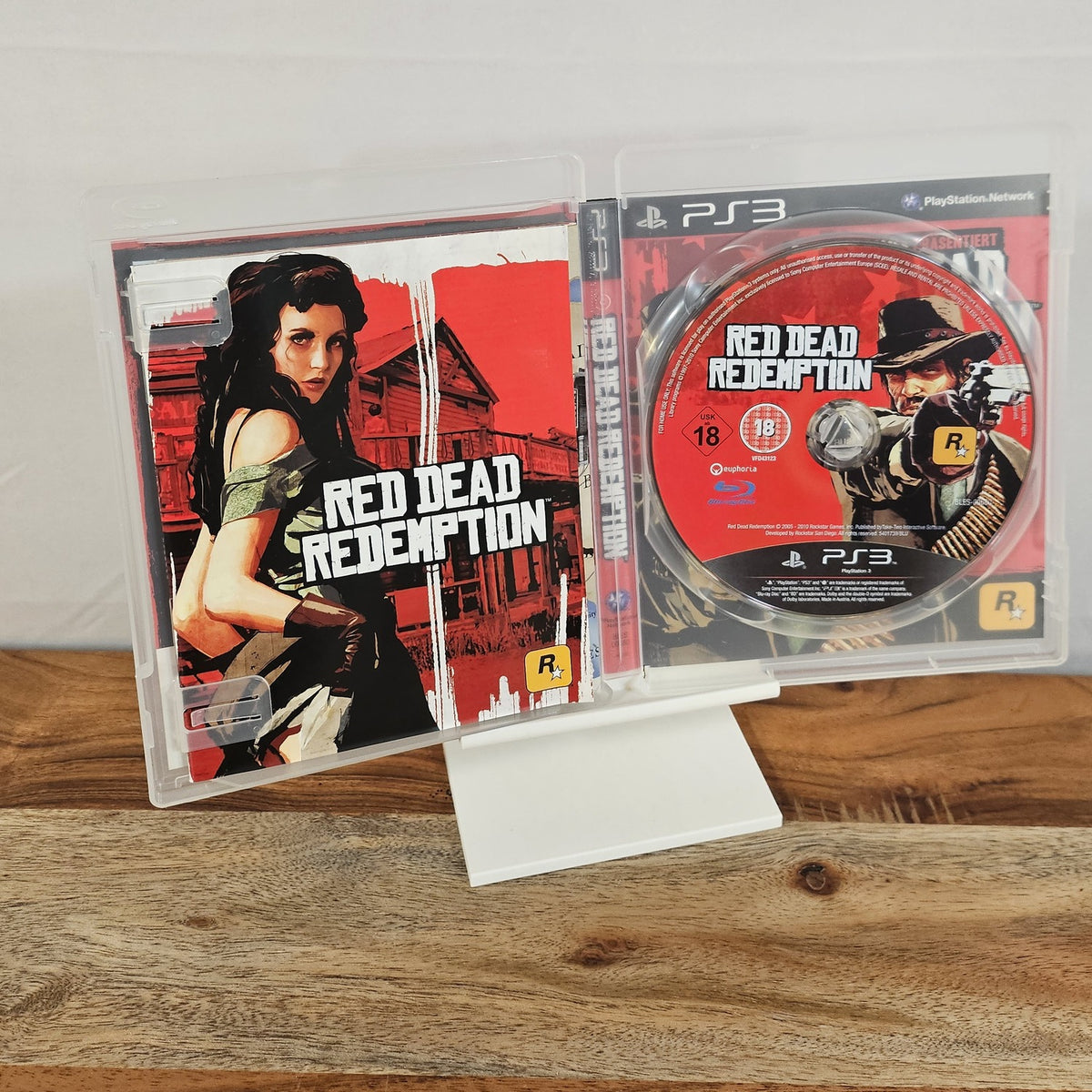 Red Dead Redemption für PlayStation 3 – geöffnete Originalhülle mit Spiel-Disc und Unterlagen