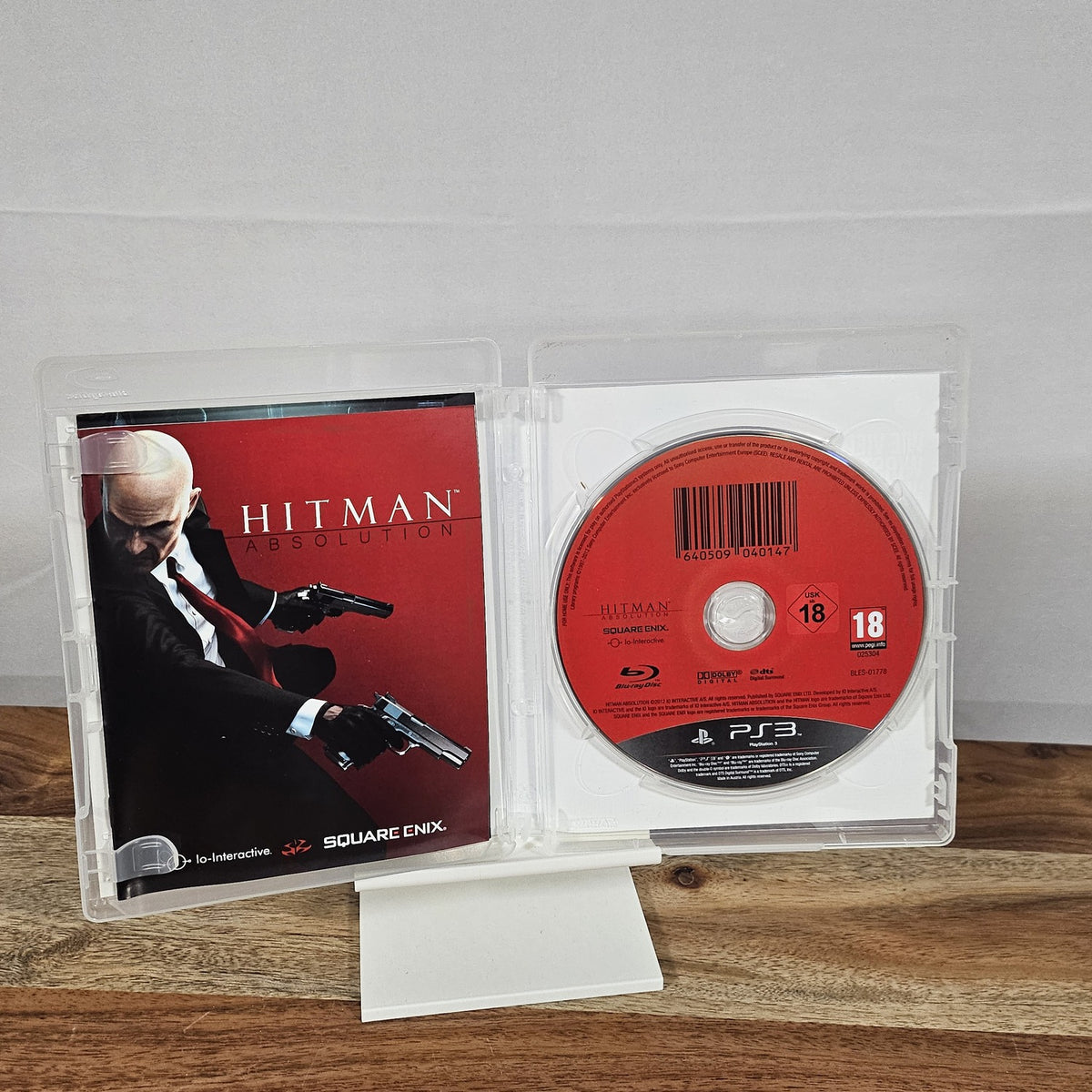 Hitman: Absolution für PlayStation 3 – geöffnete Originalhülle mit Spiel-Disc und Unterlagen