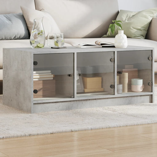 Table basse avec portes vitrées gris béton 102x50x42 cm